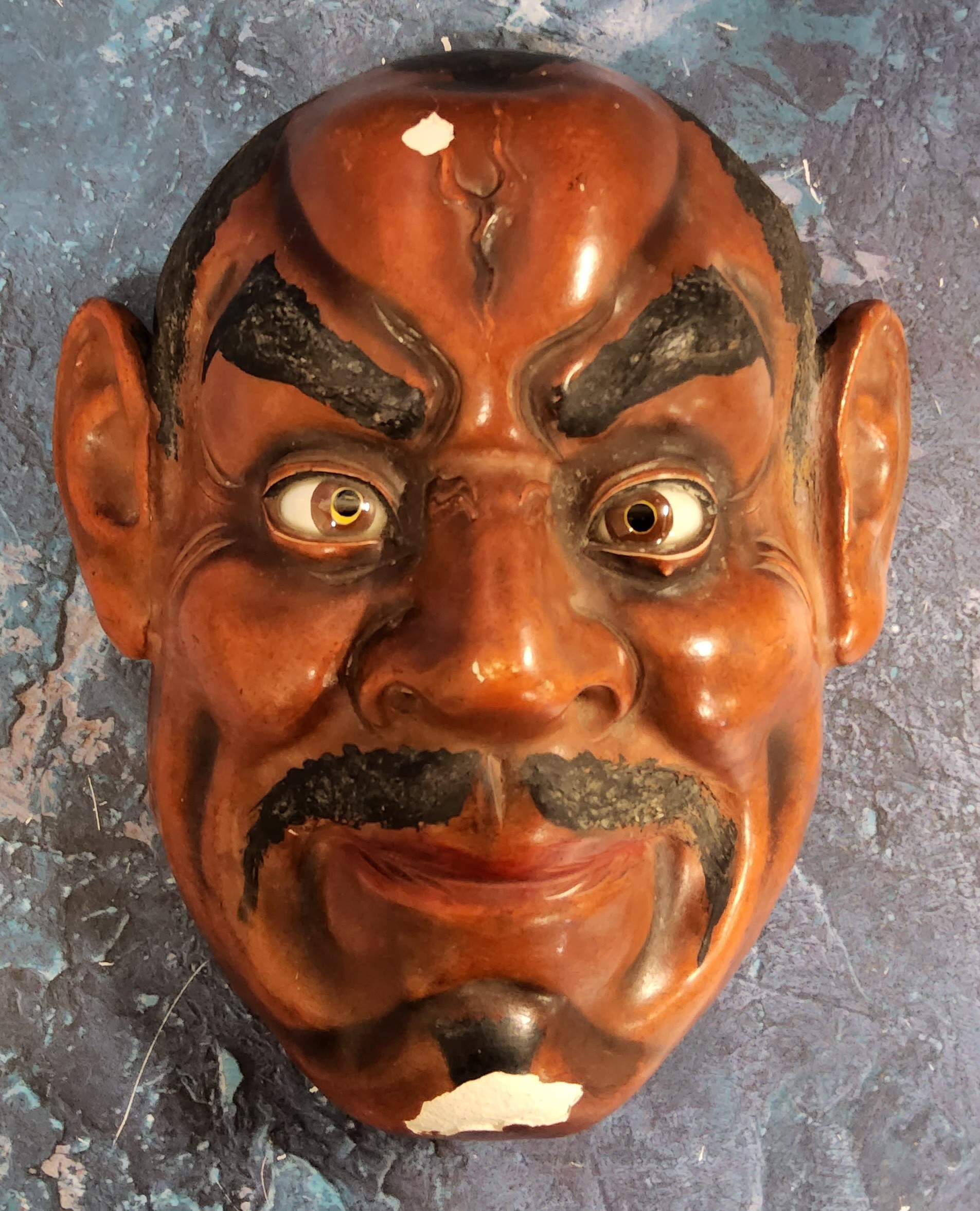 A Japanese red lacquered noh mask, 19.5cm high, early 20th century