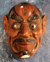 A Japanese red lacquered noh mask, 19.5cm high, early 20th century