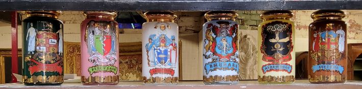 A set of six Royal Pharmaceutical Society glass pharmacists or apothecary jar and covers, of large