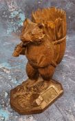 A 19th century Black Forest novelty table vesta, in the form of a bear carrying a large basket on