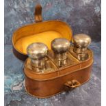An Edwardian travelling three-bottle scent case, three clear bottles, with bold domed silver covers,