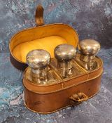 An Edwardian travelling three-bottle scent case, three clear bottles, with bold domed silver covers,
