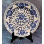 A Chinese shaped circular plate, painted in underglaze blue with stylised peonies, 25.5cm diam,