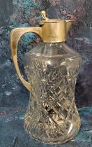 A silver mounted claret jug, of waisted cylindrical form, slice cut, hinged cover, 25cm high,