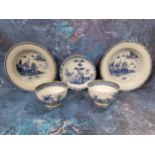 Three Chinese circular dished plates, each decorated in blue and white with pagodas, pine trees