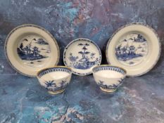 Three Chinese circular dished plates, each decorated in blue and white with pagodas, pine trees