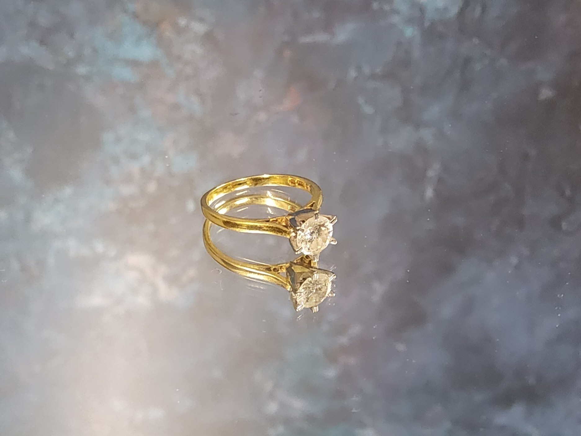 Amended description & estimate - An 18ct gold diamond solitaire ring, the claw set brilliant cut