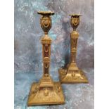 A pair of Sheffield Plated Egyptian Revival table candlesticks, urn shaped sconces, embossed with