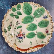 A Worcester Blind Earl pattern shaped circular plate, in relief with leaves and buds, painted with