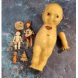 A Rose O’neill composite Kewpie, with painted side-glancing eyes, water melon smile, blue wings,