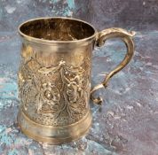 A George III silver spreading cylindrical mug, embossed with stylised flowers and leaves, 9cm