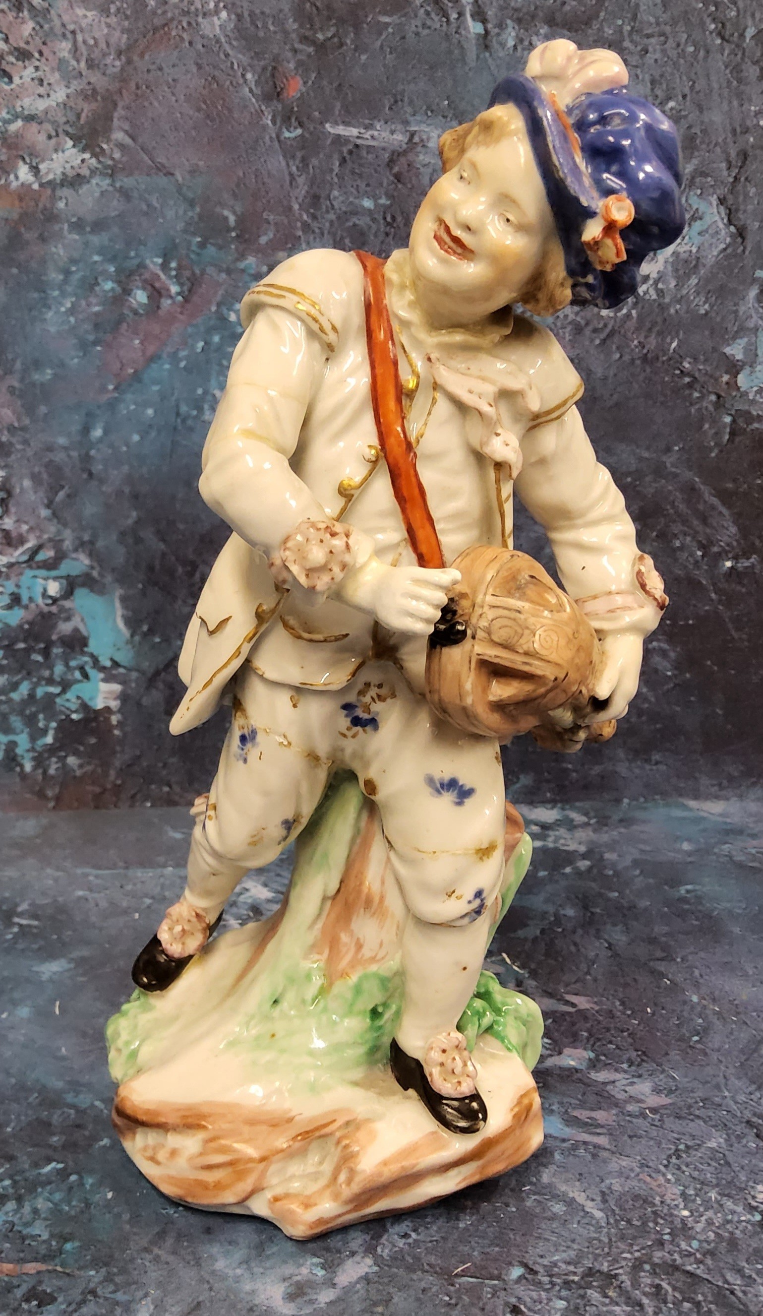 A Bristol Hurdy Gurdy figure, moulded by John Toulouse,  standing leaning on a stump, picked out