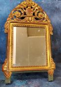 A giltwood rectangular mirror, the arched cresting pierced and carved with flowers in an urn, 67cm x