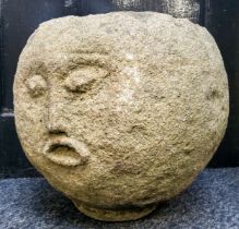An unusual Derbyshire gritstone spherical trough, carved with a face, 33cm diameter x 30cm high