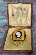 Attributed John Brogden, a Victorian yellow metal Etruscan style shell cameo mourning brooch, the