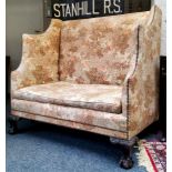 An early 20th century oak Country House high back hall sofa, leafy capped ball and claw feet,
