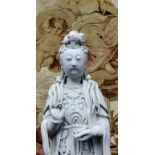 An 18th/19th century Chinese blanc de chine figure, of Guanyin, the deity modelled standing