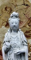 An 18th/19th century Chinese blanc de chine figure, of Guanyin, the deity modelled standing