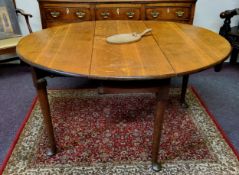 An early George III English oak oval gateleg drop leaf dining table, pegged construction, tapering