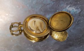 An early 19th century yellow metal circular mourning locket, the cover chased & engraved with