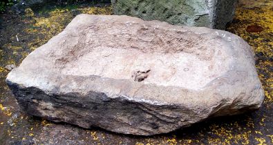 An old, nicely misshapen sandstone garden trough with drainage hole to base.