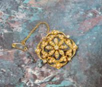 A Victorian 15ct gold floral brooch/pendant, the 'floating' centre in the form of a daisy head, a