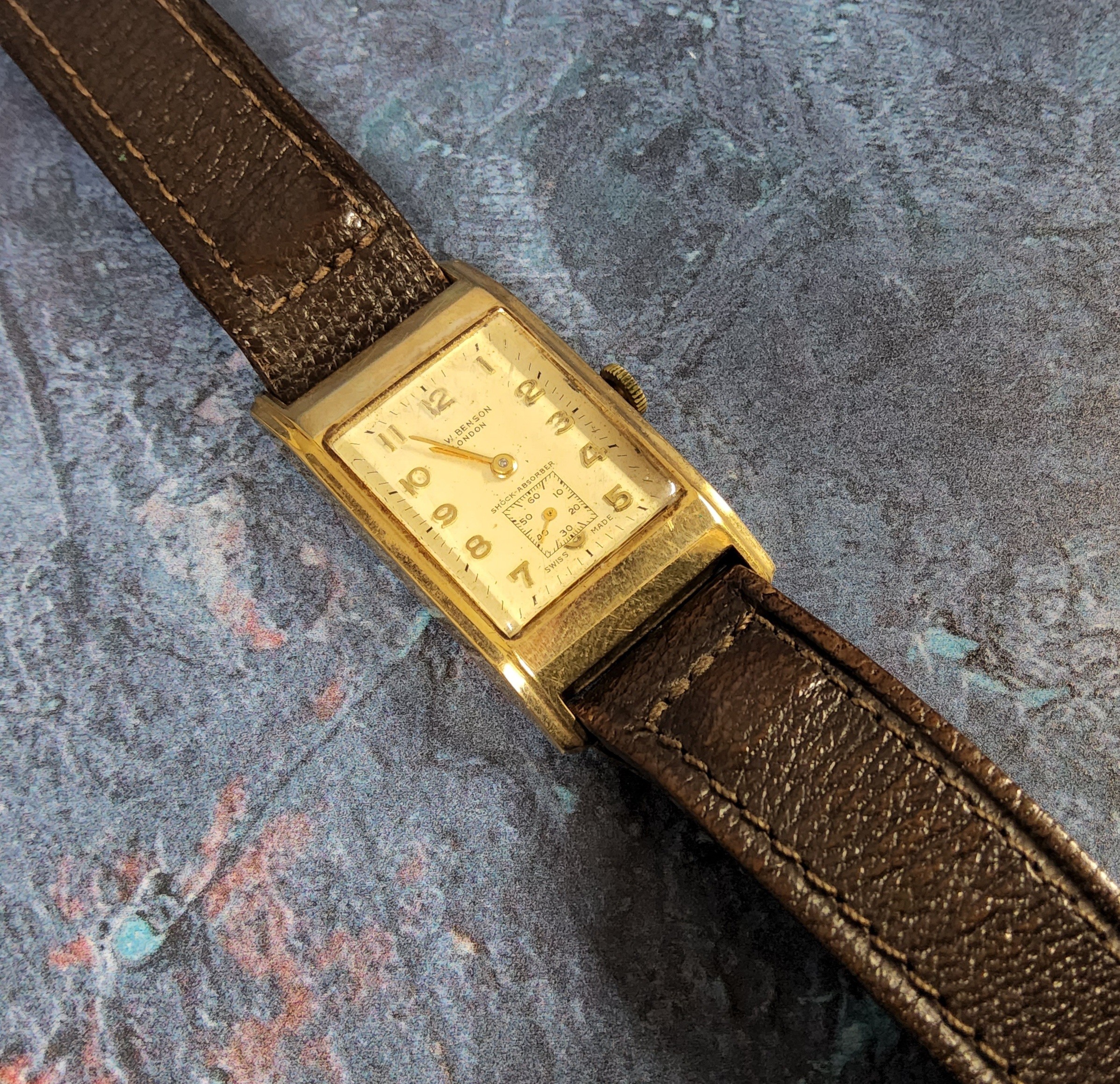 A 9ct gold gentleman's J.W. Benson tank watch, Swiss Cyma 15 jewel movement, cream dial, Arabic