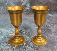 A pair of 19th century travelling goblets, the bowls unscrewing off knopped stems, stepped