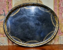 A substantial Victorian oval Papier-mâché tray, decorated in gilt with foliate swags and scrolling
