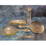 A George V silver backed dressing table set, comprising hair brush, hand mirror, clothes brush and