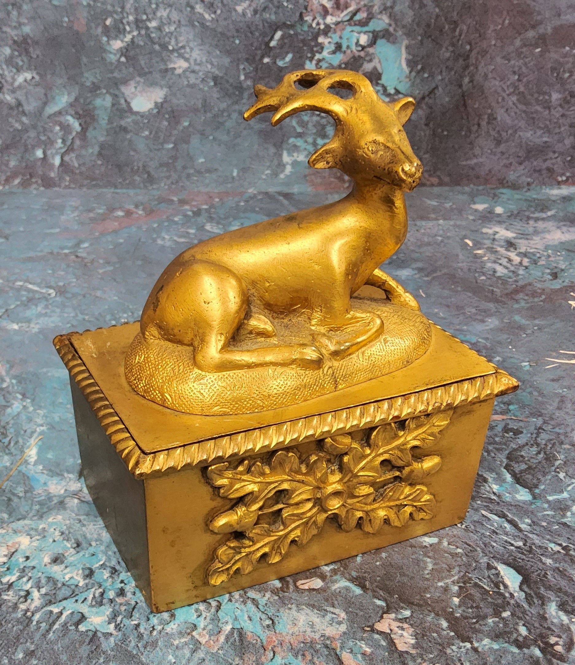 A 19th century gilt bronze rectangular desk box, the cover surmounted with a recumbent stag, the