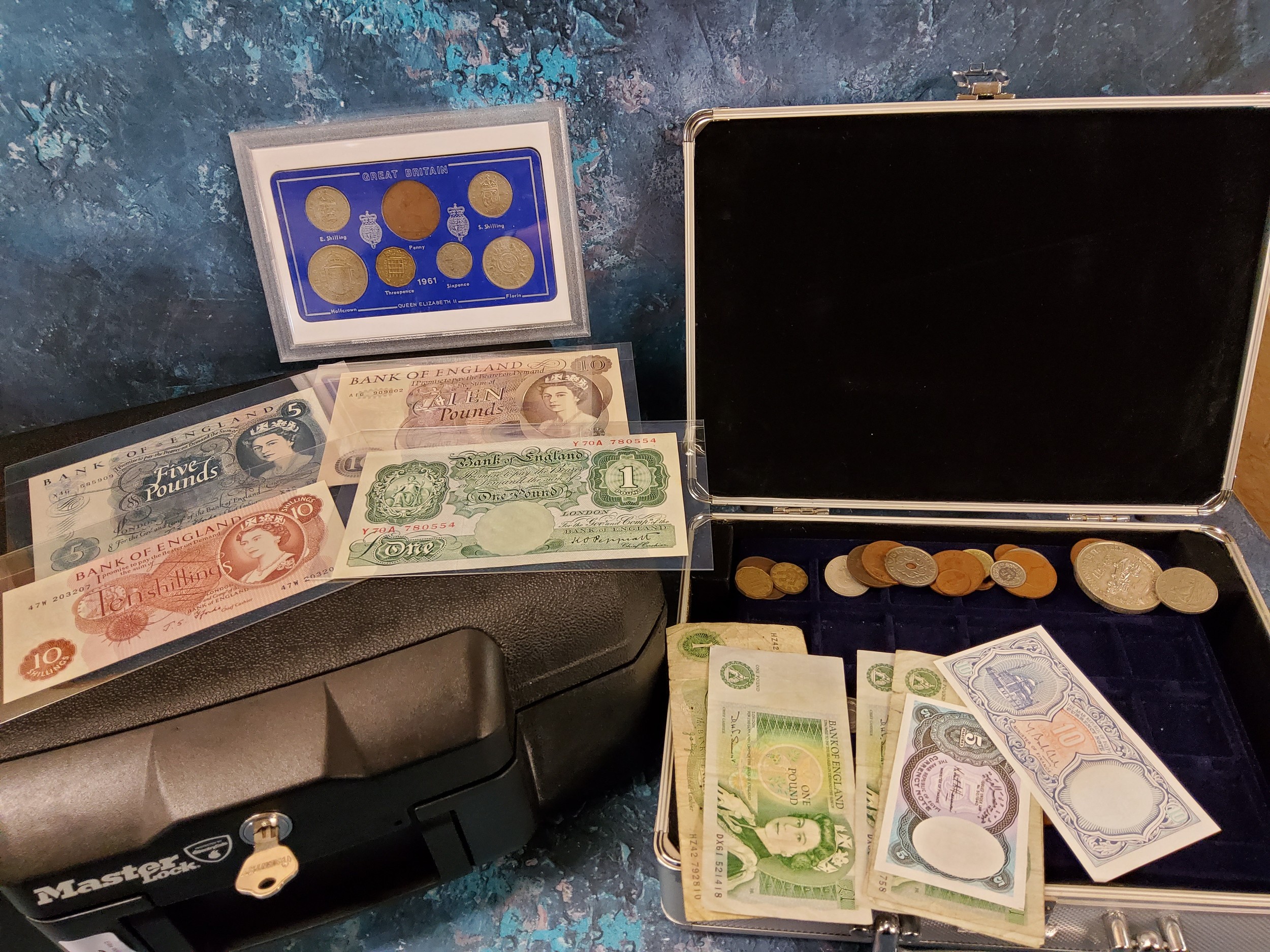 Numismatics - A Master Lock safe box, with key; a coin collector's carrying case holding mixed world