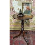 A George III oak tripod occasional table, circular top, tilting on ring turned column, scroll