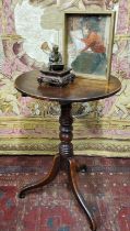 A George III oak tripod occasional table, circular top, tilting on ring turned column, scroll