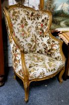 A French Louis XV Revival fauteuil à oreille, the shaped cresting carved with foliage, the wingback,