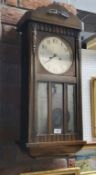 An oak wall clock, glazed door, c.1930