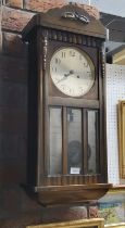 An oak wall clock, glazed door, c.1930