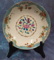 A Worcester circular saucer, the field painted with stylised flowers, the rim with stylised