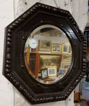 An early 20th century oak octagonal mirror, 56cm diameter