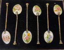 A set of six silver and enamel coffee spoons, the backs with wild flowers, cased