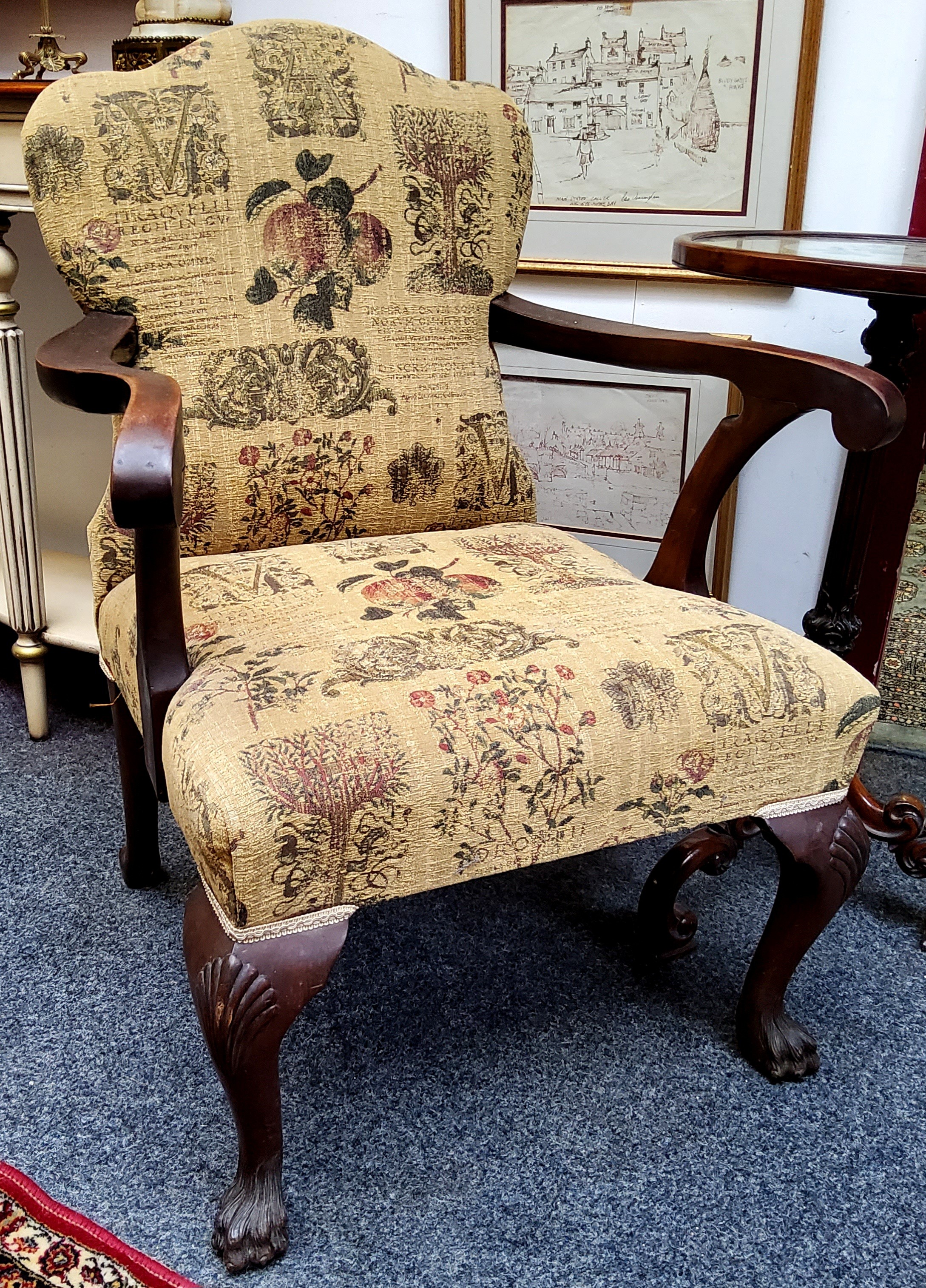 A George II style mahogany elbow chair, stuffed-over back and seat, cabriole legs, shells to