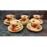 A Royal Albert Poinsettia tea service, comprising five teacups, six saucers and side plates, printed