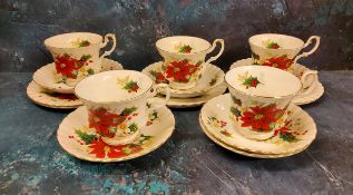 A Royal Albert Poinsettia tea service, comprising five teacups, six saucers and side plates, printed