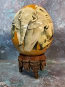An ostrich egg, painted with African Big Five, 16cm high, wooden stand