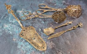 A Continental silver cake slice, embossed in relief flowers and foliage,  the handle terminating