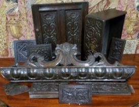 An 18th century oak door panel, carved with stylised flowers, 43cm x 38cm, c.1740;  others (9)