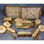 A mid 20th century gilt metal dressing table set, the backs embroidered with bouquet of flowers, c.