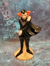 A Carlton Ware Mephisto Series figure, he stands, wearing a black cape, 11cm high, printed mark
