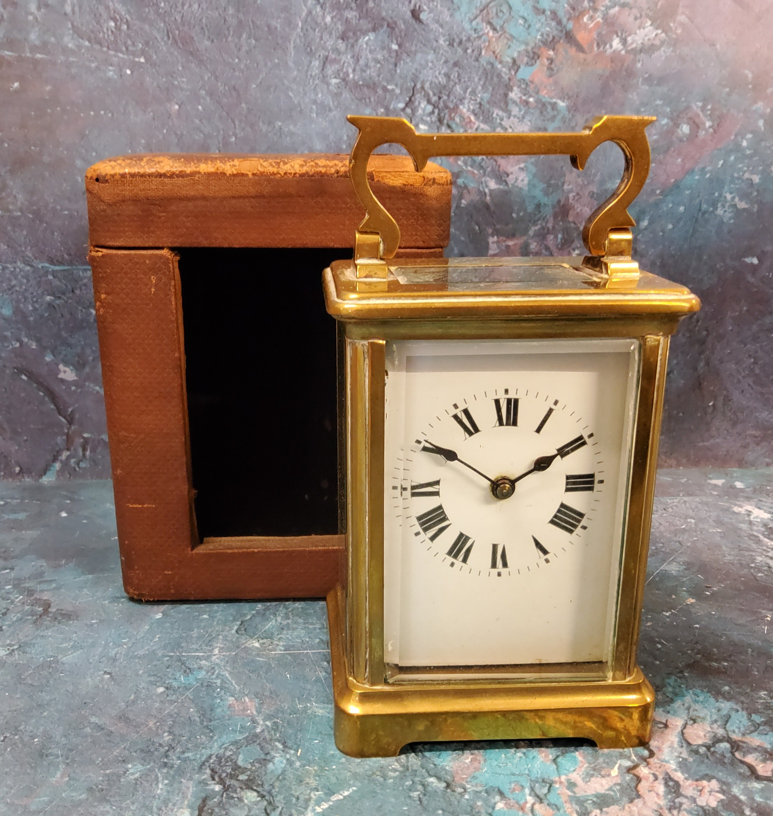 A French gilt carriage clock, Roman numerals, swing handle, 14.5cm high, morocco case