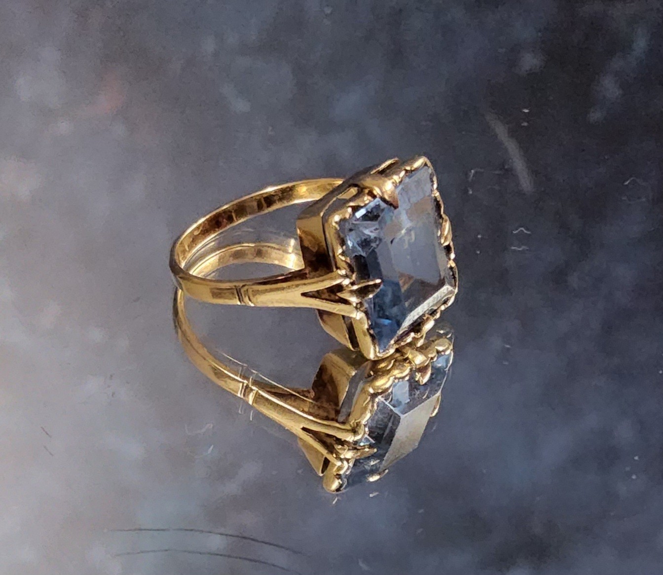 A Dutch 14ct gold cocktail ring, set with an emerald cut blue topaz, size M 1/2, 3.85g gross